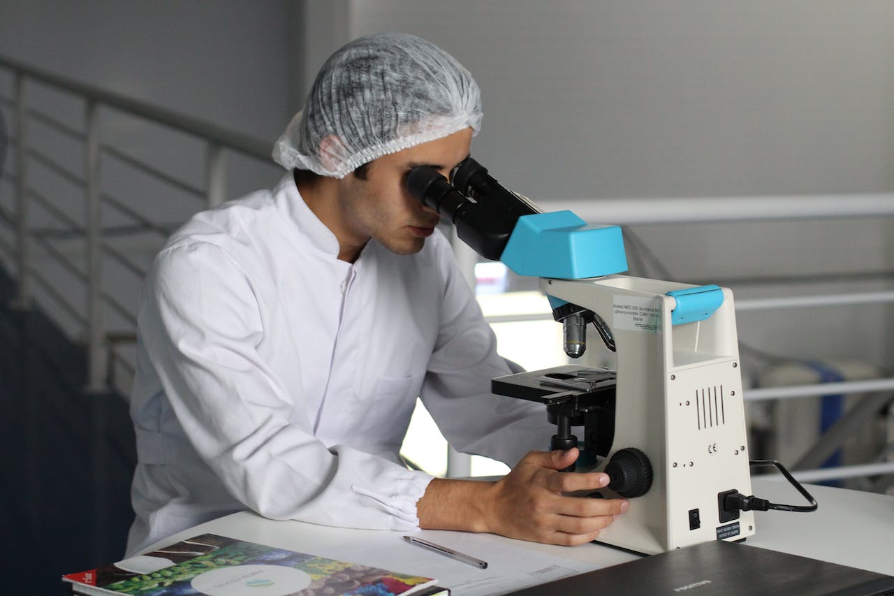 A scientist looking through a microscope
